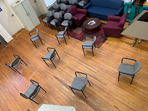 Eight chairs spaced six feet apart.